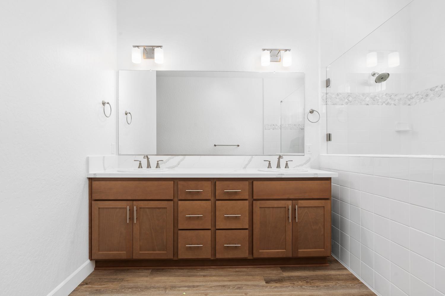 276 Huckleberry Lane South Madera, CA 93636 - Photo 27 of 32 a bathroom with a double vanity sink and a mirror