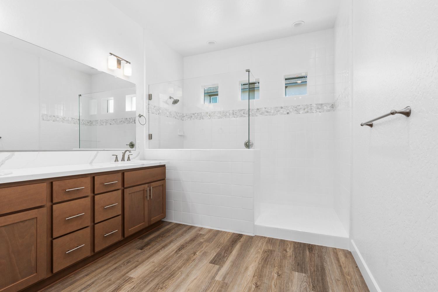 276 Huckleberry Lane South Madera, CA 93636 - Photo 28 of 32 a spacious bathroom with a double vanity sink a mirror and a shower