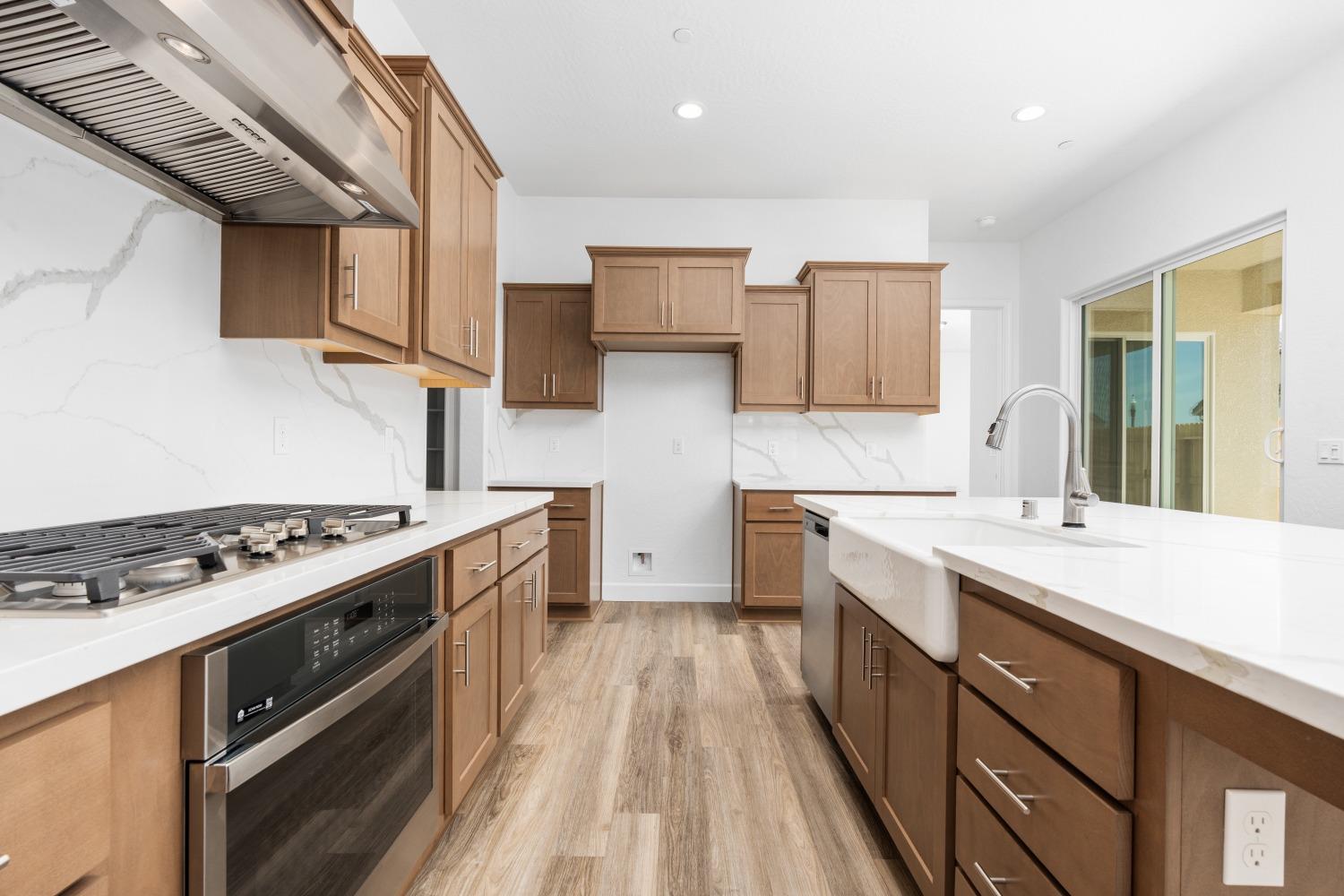 276 Huckleberry Lane South Madera, CA 93636 - Photo 6 of 32 a kitchen with stainless steel appliances a sink stove and cabinets