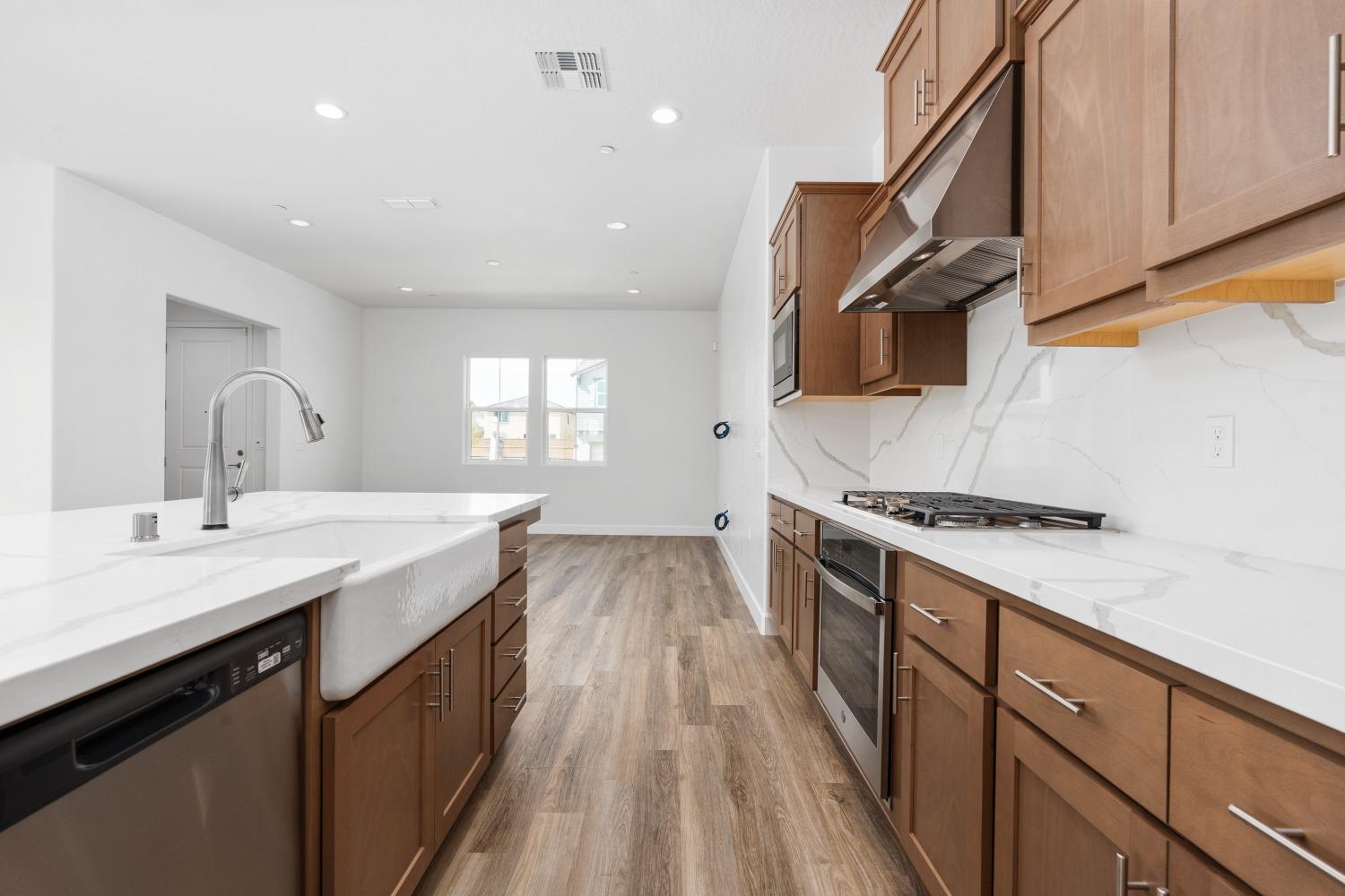 276 Huckleberry Lane South Madera, CA 93636 - Photo 8 of 32 a kitchen with a sink stove top oven and microwave