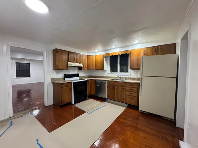 a kitchen with stainless steel appliances a refrigerator stove and microwave