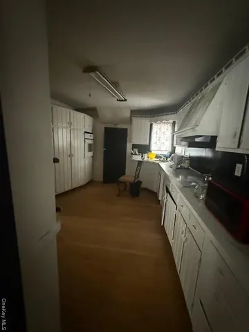 a kitchen with sink cabinets and window