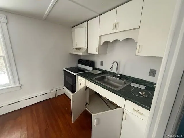 a kitchen with a sink stove and cabinets