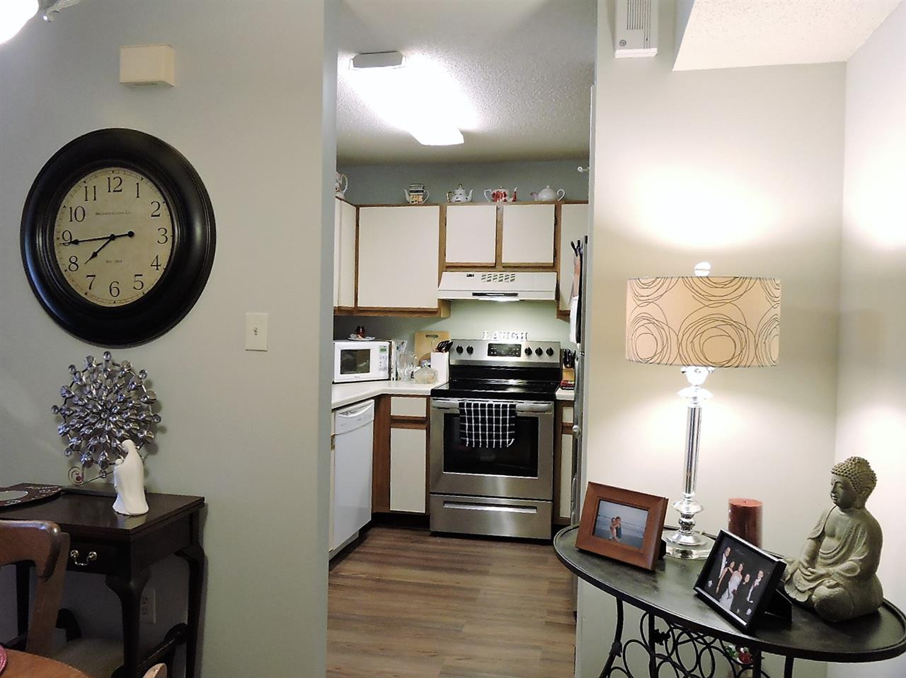 3702 Chimney Ridge Place, Unit 206 Durham, NC 27713 - Photo 13 of 19 a kitchen with a stove a sink and a refrigerator