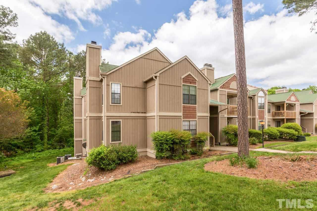3702 Chimney Ridge Place, Unit 206 Durham, NC 27713 - Photo 18 of 19 a view of a white house next to a yard with big trees