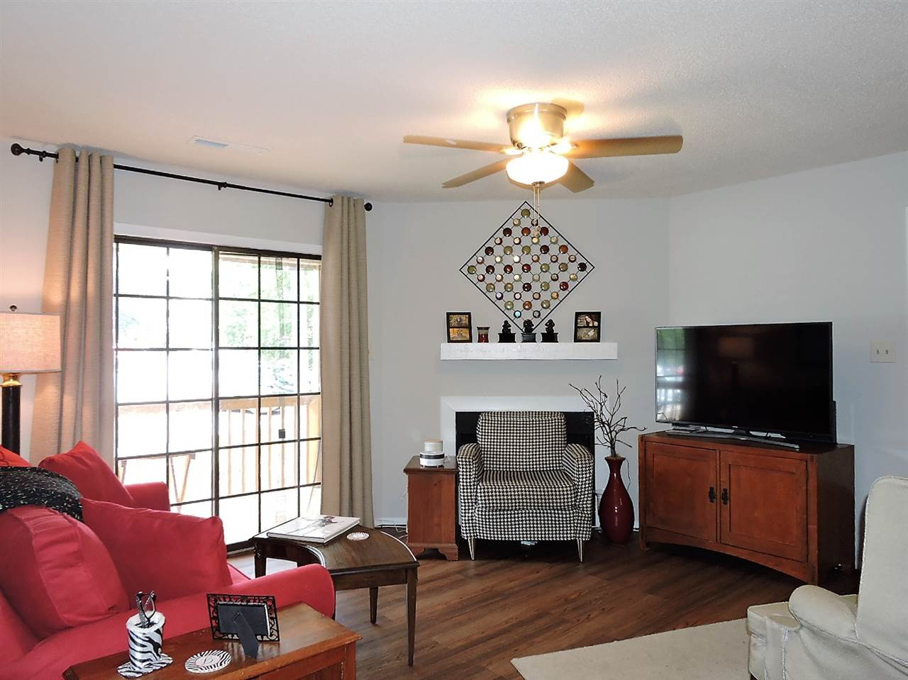 3702 Chimney Ridge Place, Unit 206 Durham, NC 27713 - Photo 3 of 19 a living room with furniture a flat screen tv and a window