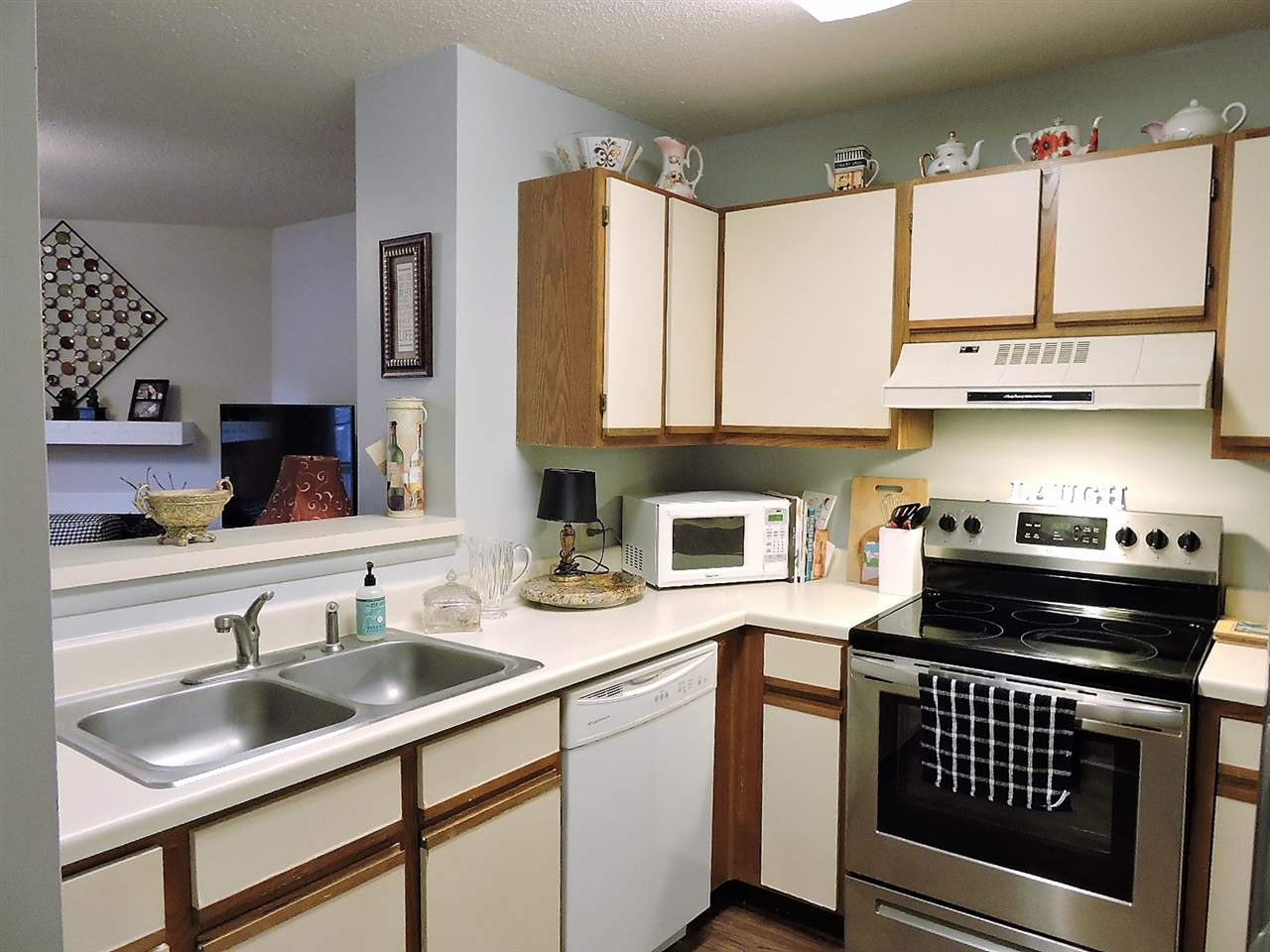 3702 Chimney Ridge Place, Unit 206 Durham, NC 27713 - Photo 5 of 19 a kitchen with a sink stove top oven and cabinets