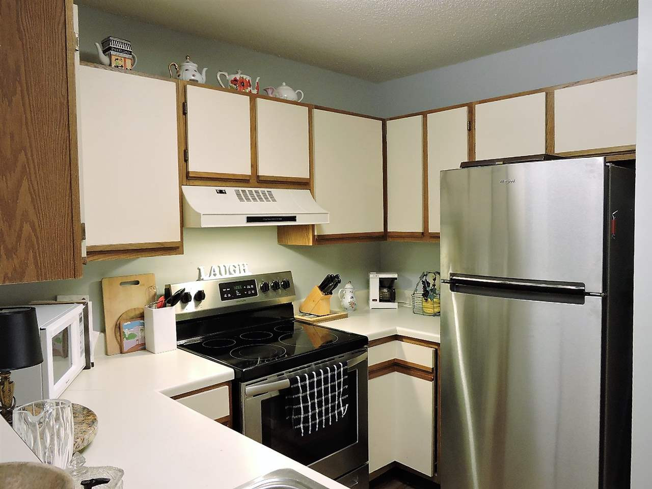 3702 Chimney Ridge Place, Unit 206 Durham, NC 27713 - Photo 9 of 19 a kitchen with a refrigerator a sink and a stove