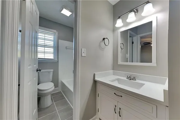 a bathroom with a sink a toilet a shower and a mirror