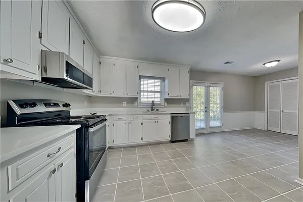 a kitchen with a stove cabinets and a sink