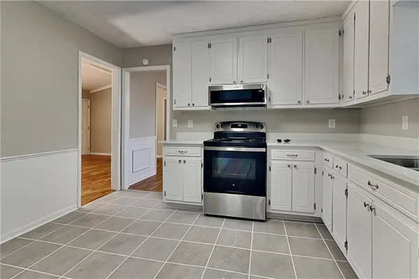 a kitchen with a stove top oven and cabinets
