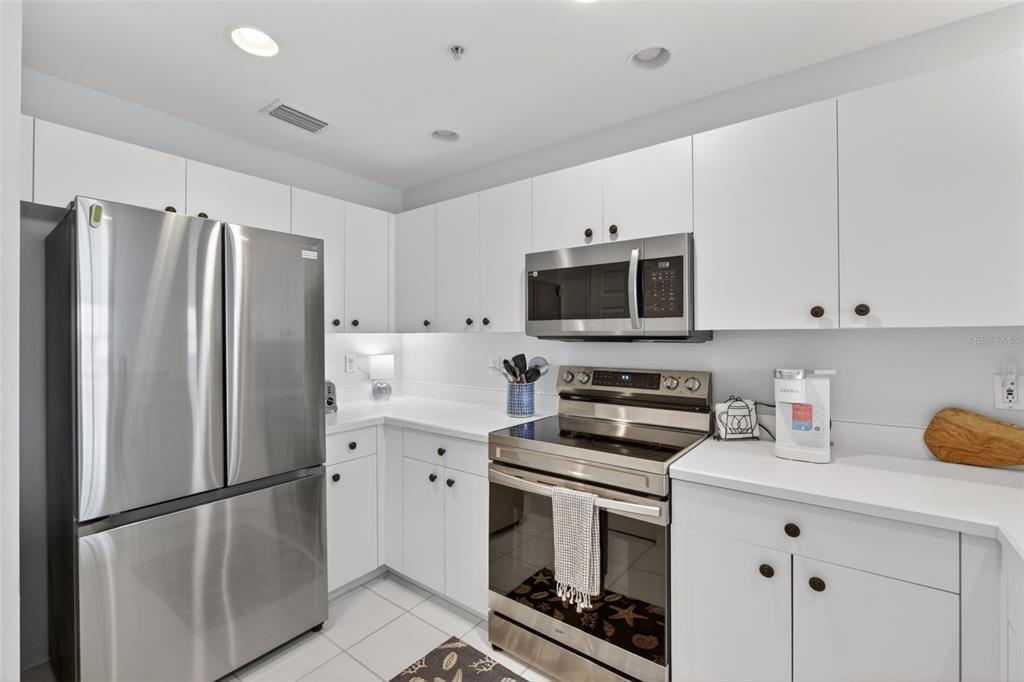 2090 Matecumbe Key Road, Unit 1603 Punta Gorda, FL 33955 - Photo 12 of 47 a kitchen with stainless steel appliances a refrigerator sink and microwave