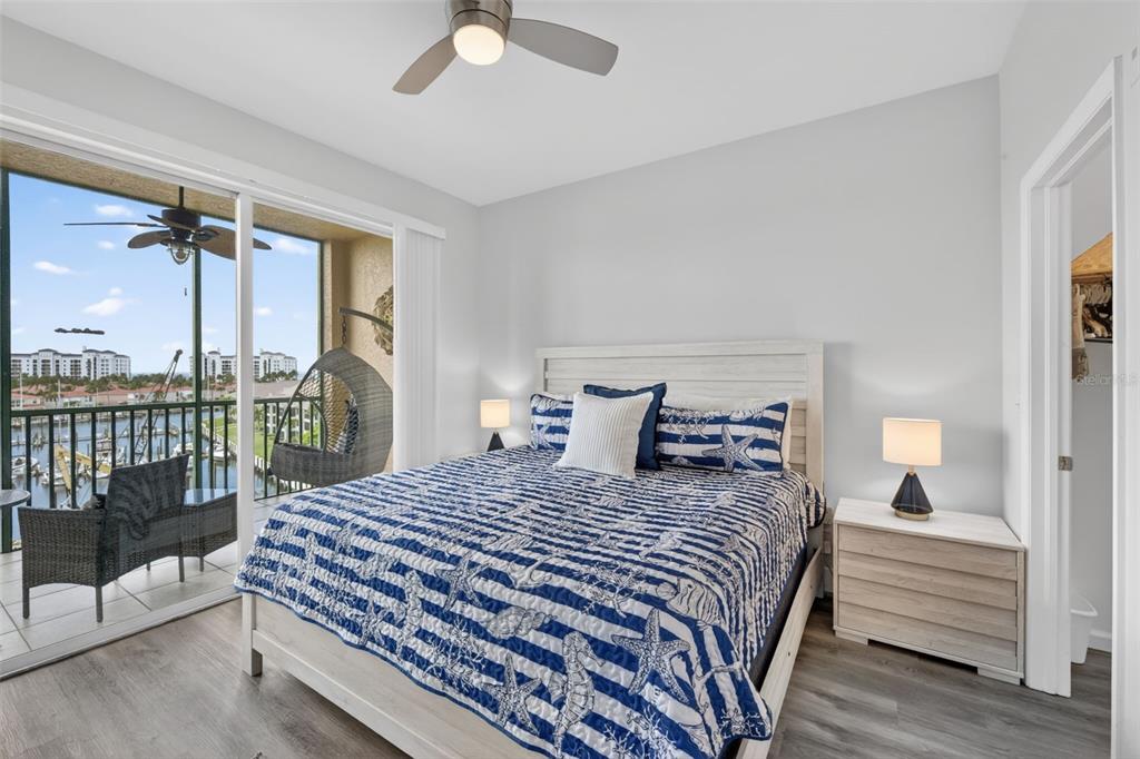 2090 Matecumbe Key Road, Unit 1603 Punta Gorda, FL 33955 - Photo 16 of 47 a bedroom with a balcony a bed and a chandelier