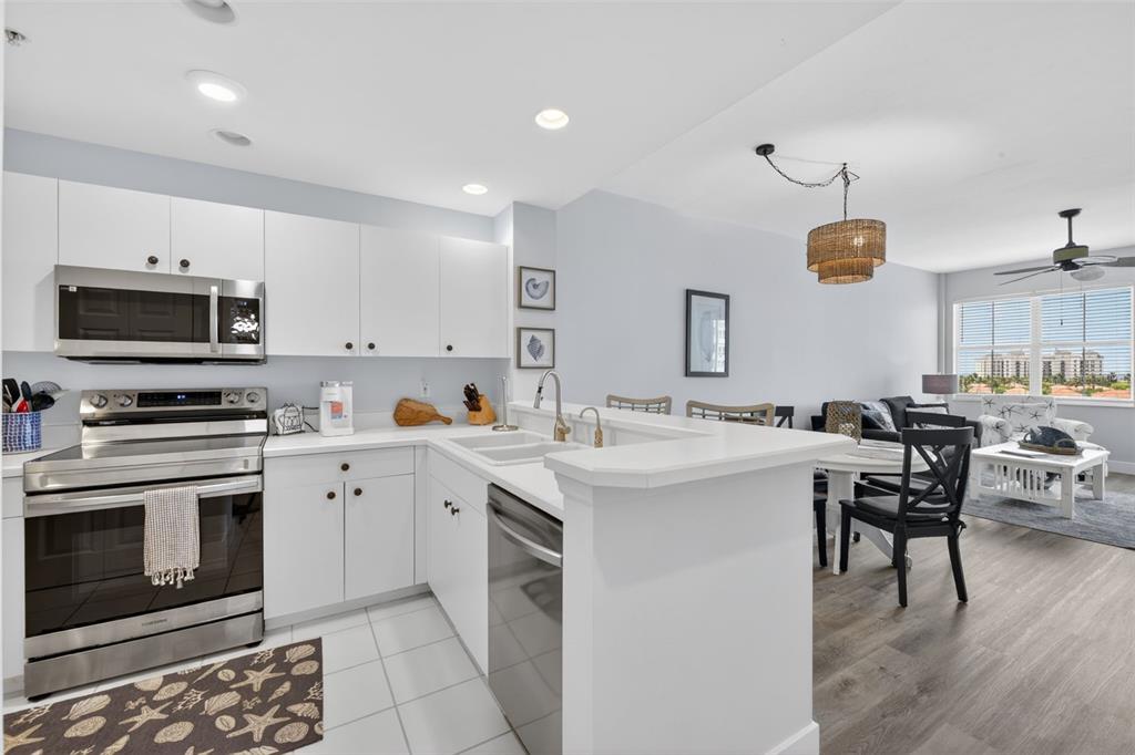 2090 Matecumbe Key Road, Unit 1603 Punta Gorda, FL 33955 - Photo 2 of 47 a kitchen with a sink stove and white cabinets