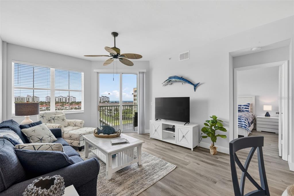 2090 Matecumbe Key Road, Unit 1603 Punta Gorda, FL 33955 - Photo 25 of 47 a living room with furniture a flat screen tv and a floor to ceiling window