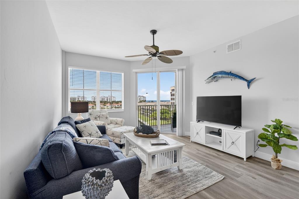 2090 Matecumbe Key Road, Unit 1603 Punta Gorda, FL 33955 - Photo 3 of 47 a living room with furniture a flat screen tv and a floor to ceiling window