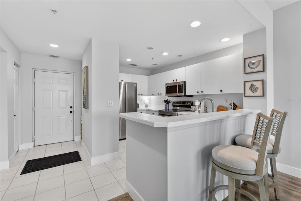 2090 Matecumbe Key Road, Unit 1603 Punta Gorda, FL 33955 - Photo 5 of 47 a kitchen with stainless steel appliances a refrigerator and a stove top oven