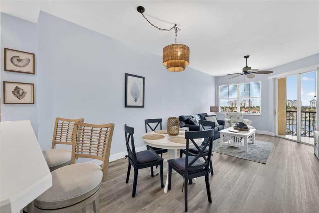 2090 Matecumbe Key Road, Unit 1603 Punta Gorda, FL 33955 - Photo 9 of 47 a view of a dining room with furniture and wooden floor