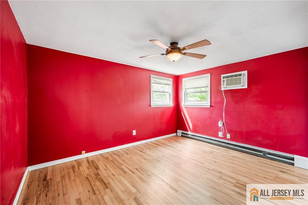 67 Drake Place Colonia, NJ 07067 - Photo 15 of 31 a view of a big room with wooden floor and windows