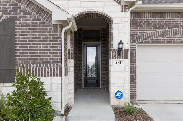a front view of a house with a glass door