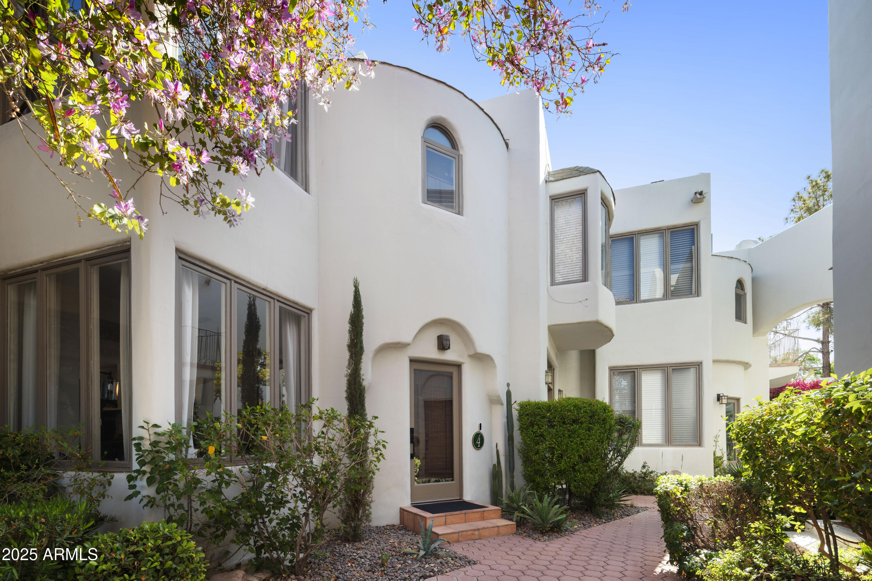 4955 East Indian School Road, Unit 4 Phoenix, AZ 85018 - Photo 1 of 1 a front view of a house with a garden