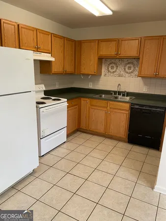 a kitchen with stainless steel appliances granite countertop a refrigerator sink and cabinets