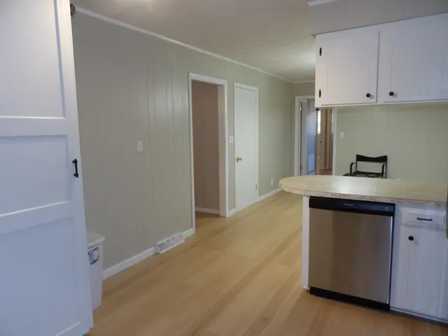 a view of a white house with a yard