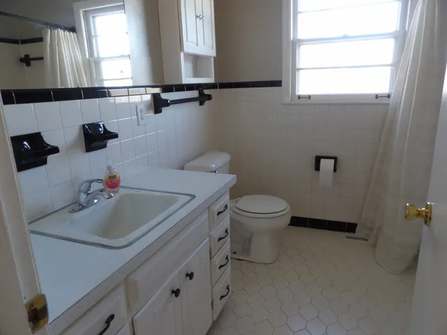 a view of a kitchen with a sink and dishwasher a refrigerator with wooden floor
