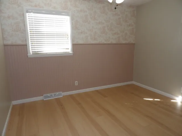 a view of an empty room with a fireplace