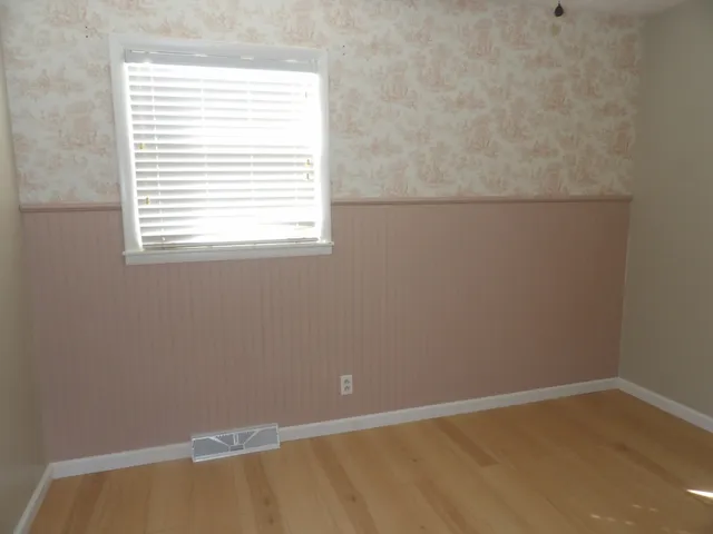 a kitchen with stainless steel appliances granite countertop a refrigerator a stove a sink and white cabinets