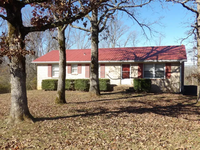 an empty room with a window and ceiling fan