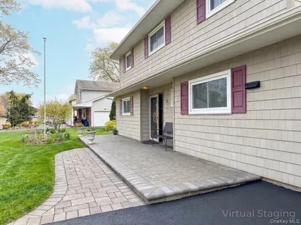 a living room with furniture a chandelier and a rug