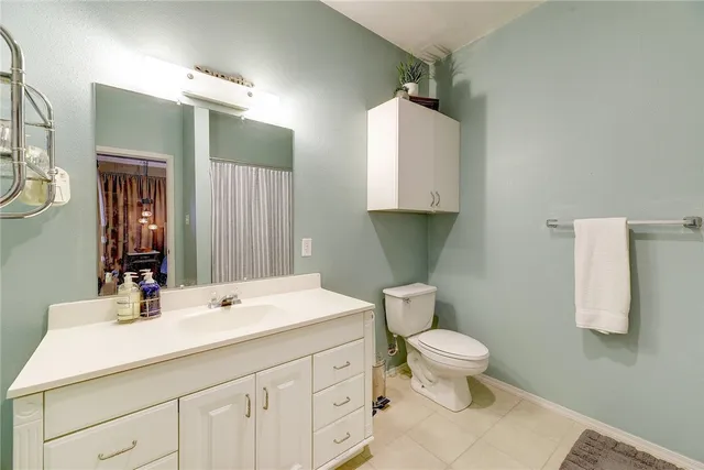 a bathroom with a sink toilet and mirror