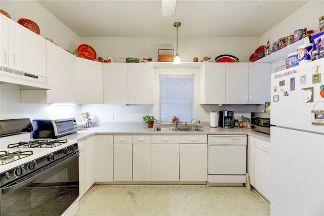 a kitchen with stainless steel appliances granite countertop a sink and a stove