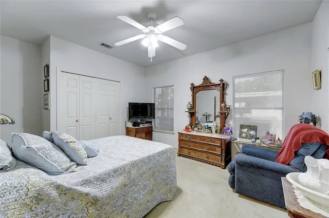 a bedroom with a bed a couch and dresser