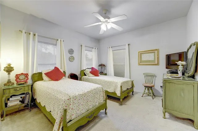 a bedroom with two beds and a flat screen tv