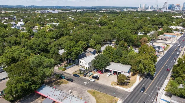 an aerial view of residential house with outdoor space and trees