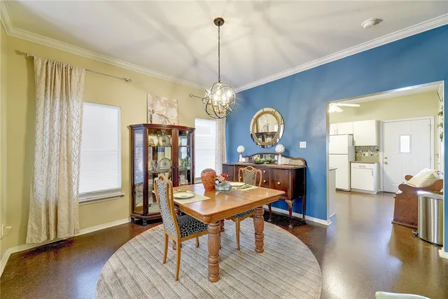 a view of a a dining room with furniture window and wooden floor