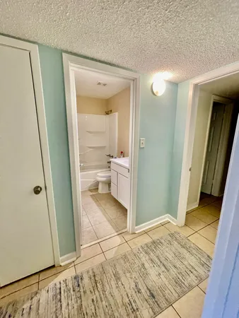a bathroom with a sink and mirror with toilet