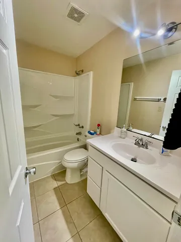 a bathroom with a double vanity sink toilet and shower