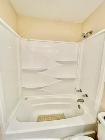 a bathroom with a double vanity sink toilet and shower