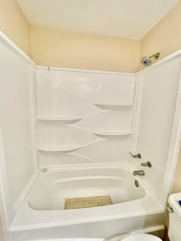 a bedroom with a bed and a night stand