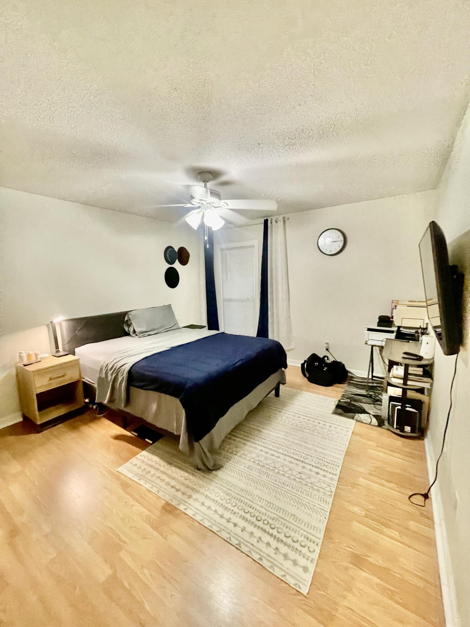 210 Pelham Road, Unit 214A Fort Walton Beach, FL 32547 - Photo 15 of 17 a bedroom with a bed and a night stand