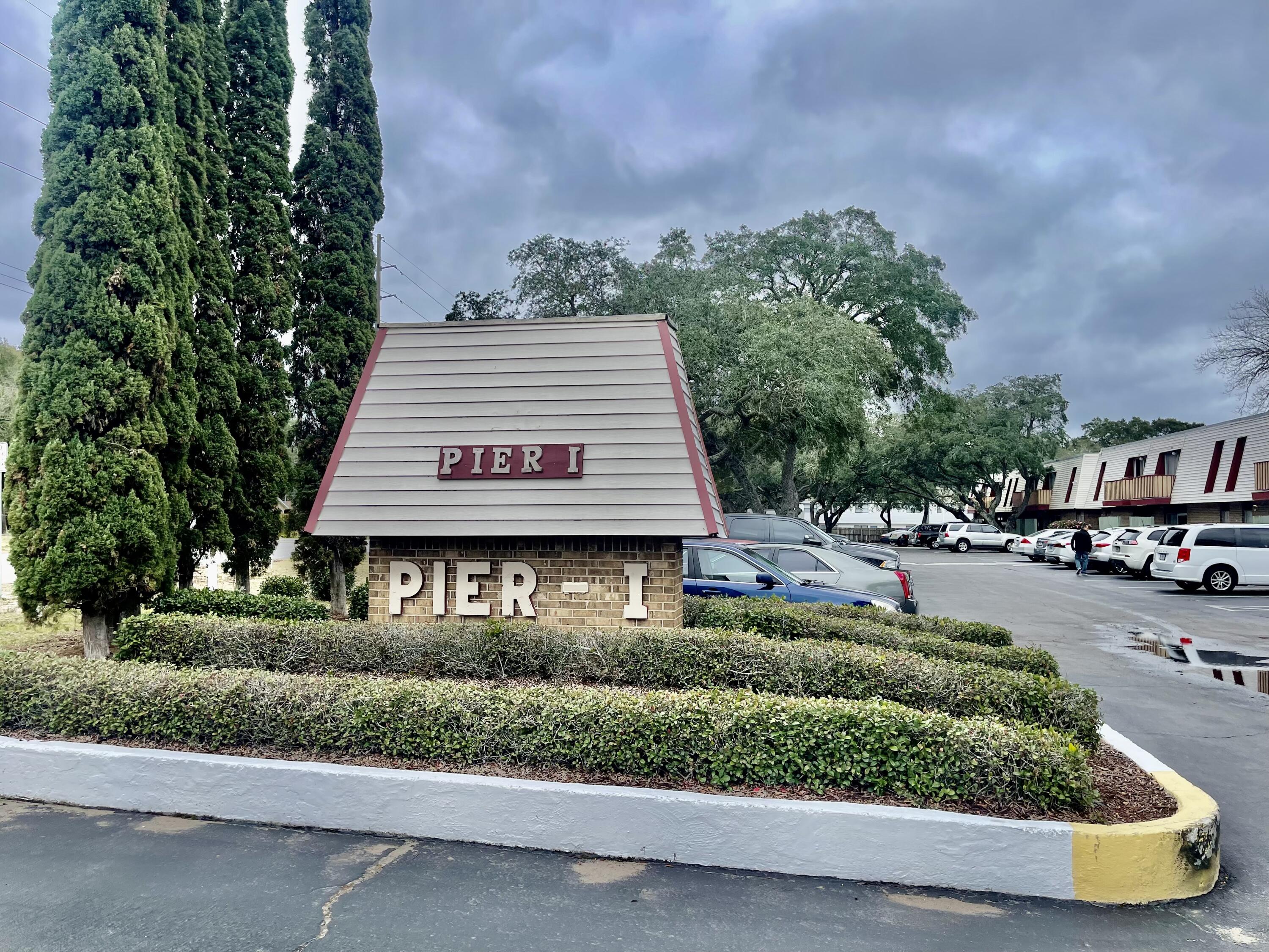 210 Pelham Road, Unit 214A Fort Walton Beach, FL 32547 - Photo 2 of 17 a front view of a house with a garden and plants