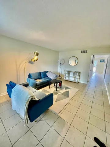 a view of a hallway with a chandelier