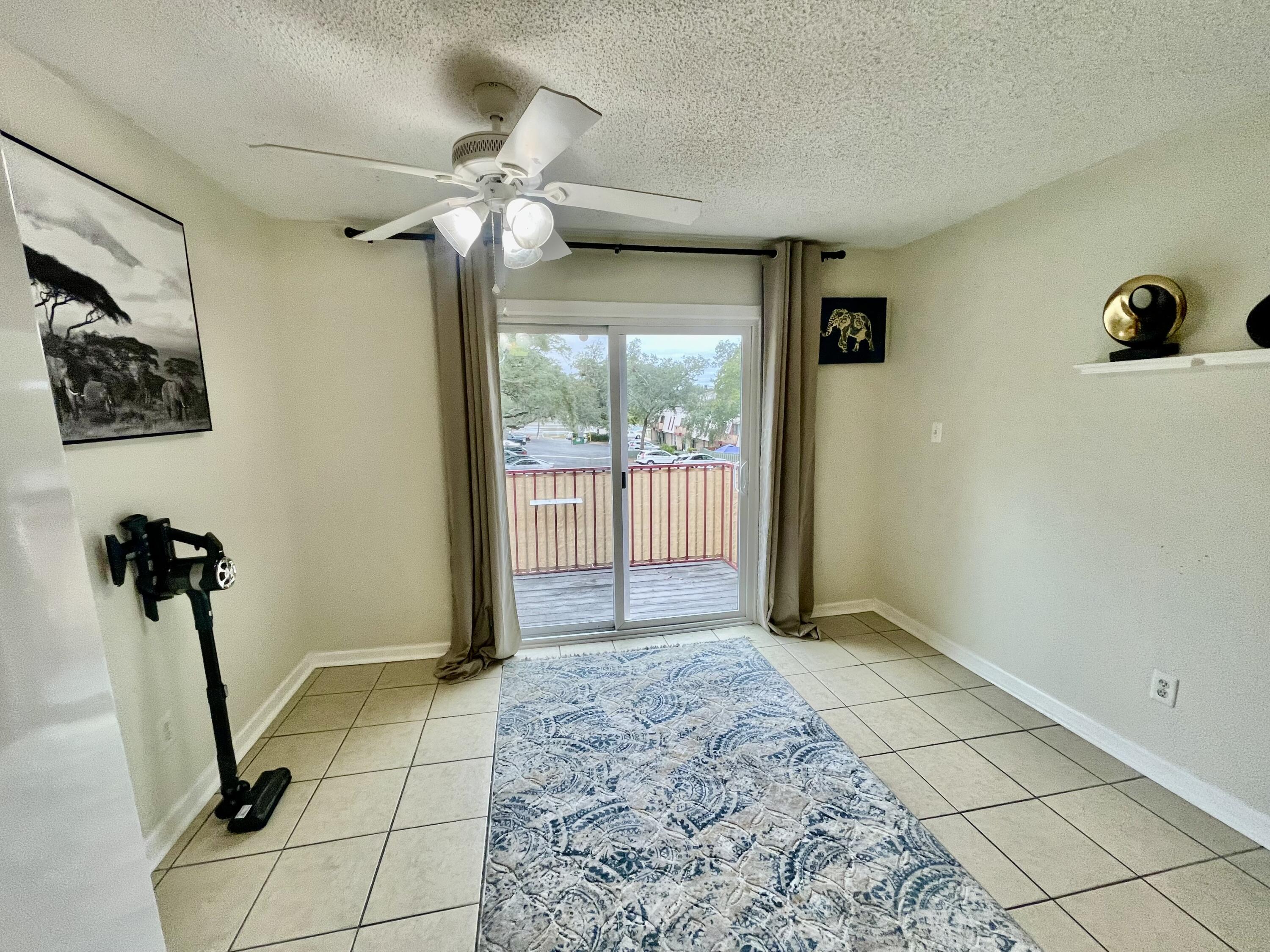210 Pelham Road, Unit 214A Fort Walton Beach, FL 32547 - Photo 5 of 17 a view of a hallway with a chandelier