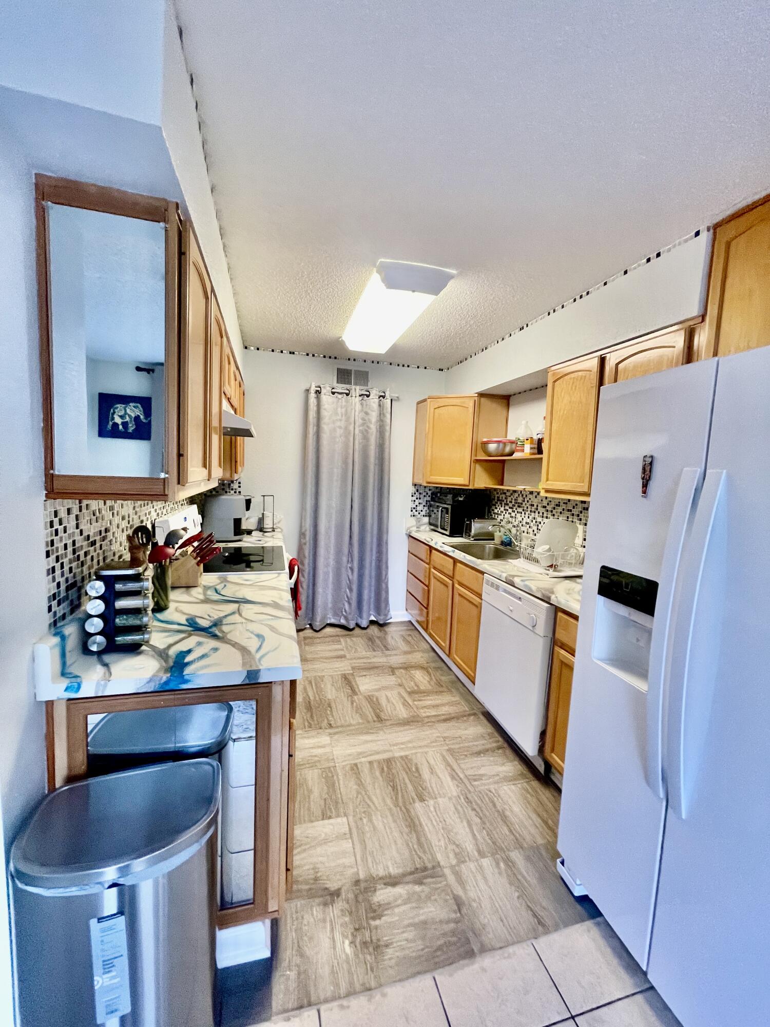 210 Pelham Road, Unit 214A Fort Walton Beach, FL 32547 - Photo 6 of 17 a kitchen with granite countertop a sink stove and refrigerator