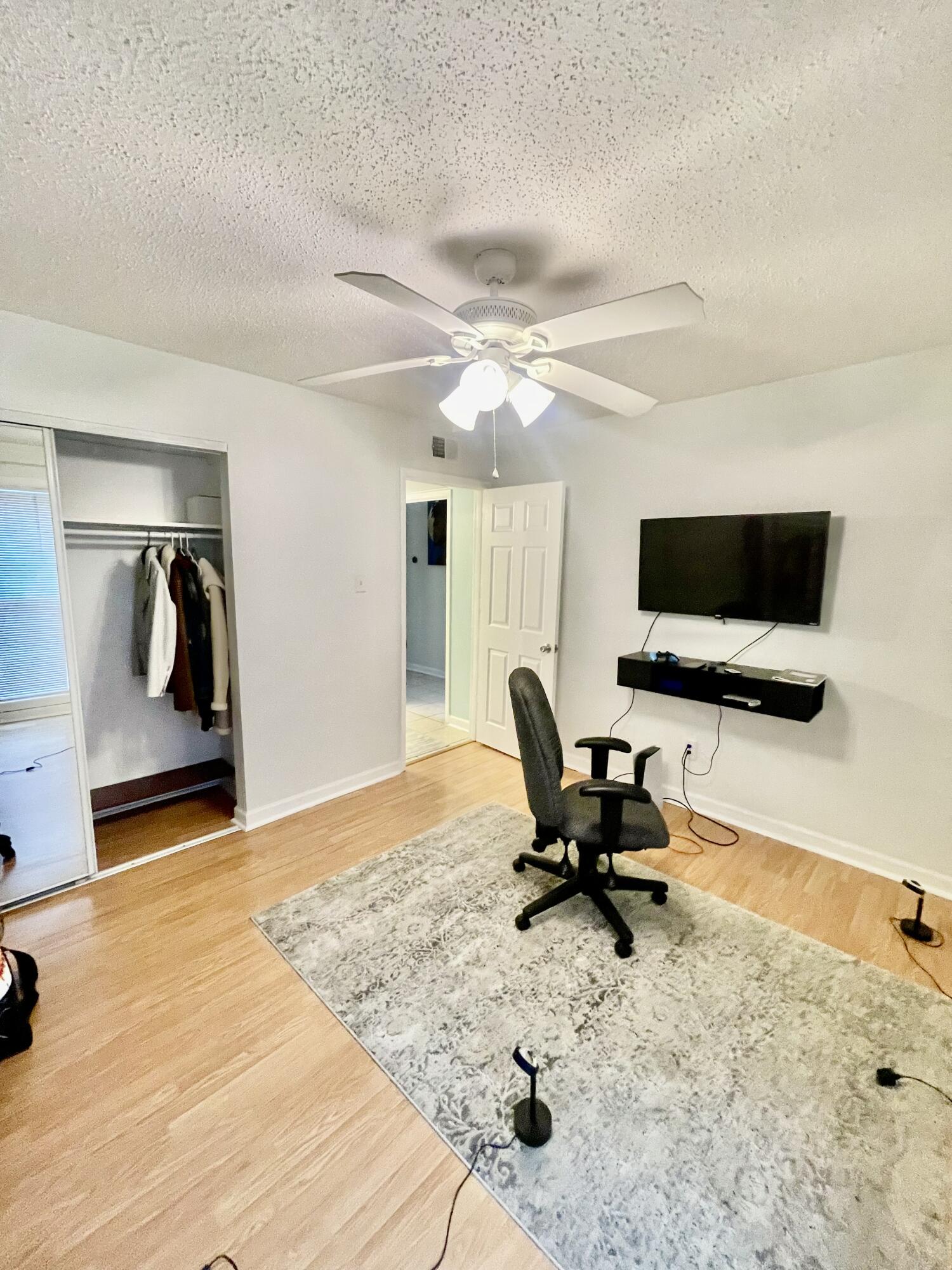 210 Pelham Road, Unit 214A Fort Walton Beach, FL 32547 - Photo 10 of 17 a living room with furniture and a flat screen tv