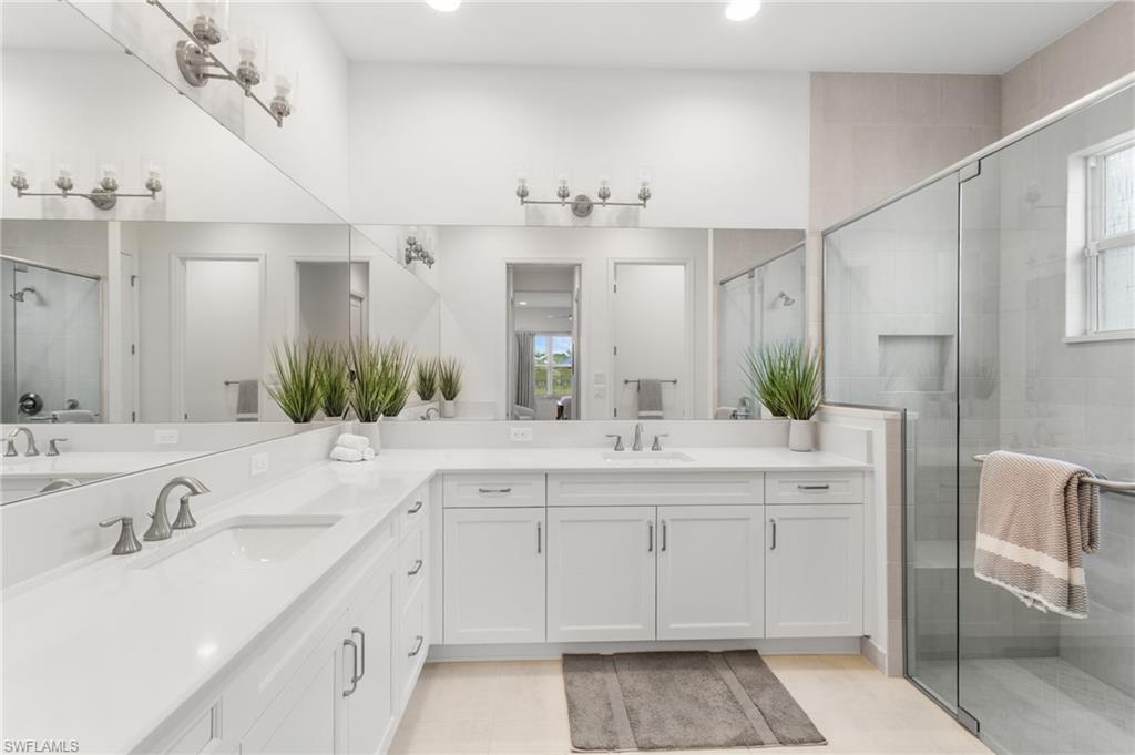 12370 Purple Ficus Way Naples, FL 34120 - Photo 17 of 50 Bathroom featuring a shower stall, double vanity, plenty of natural light, and recessed lighting