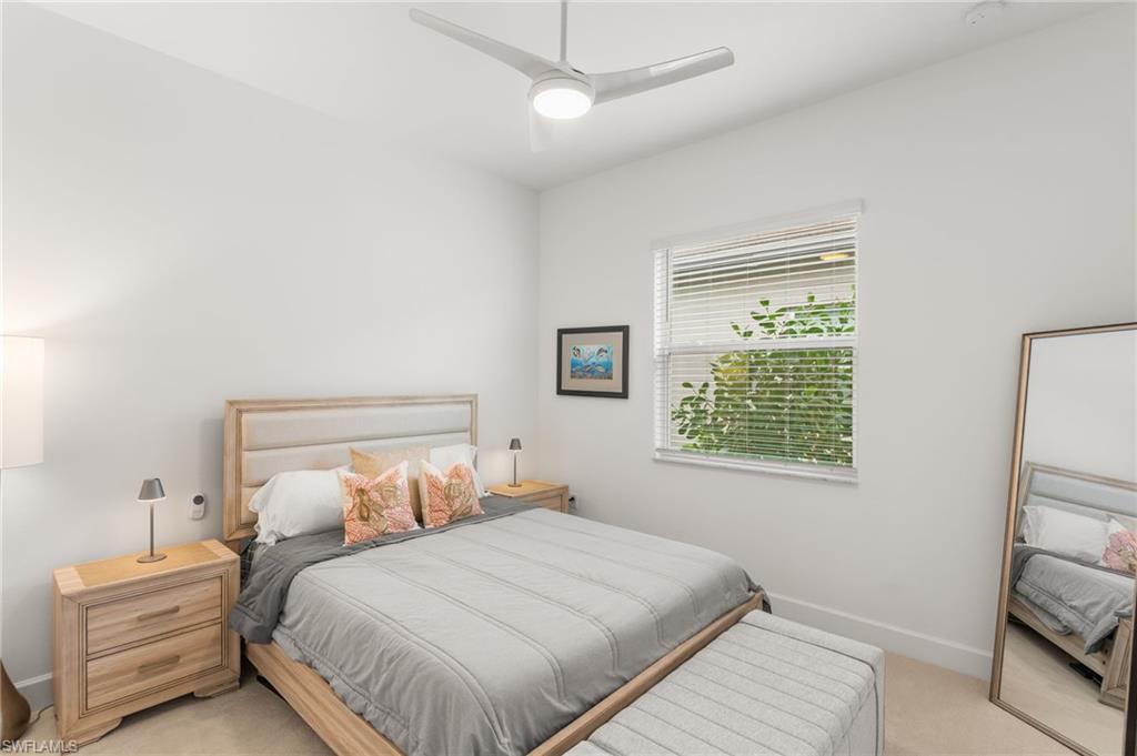 12370 Purple Ficus Way Naples, FL 34120 - Photo 21 of 50 Bedroom with light carpet and a ceiling fan